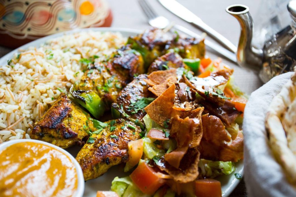 Indulge in delicious Moroccan cuisine and aromatic spices.